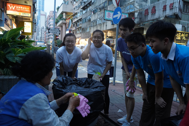 Ehren, Loy, Ivan, Rachael and Ceci (from right) invite cleaners to try on the ‘Protective Gloves’, hoping to arouse public concern for these people through action.