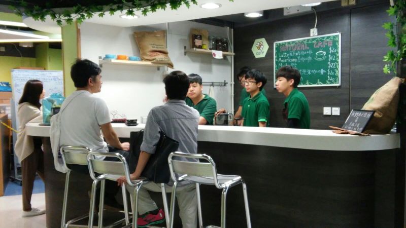 Apprentices communicate with customers at the Natural Cafe as part of the training for communication skills and boosting their courage.